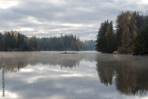 Calm lake in misty morning. © tommitt