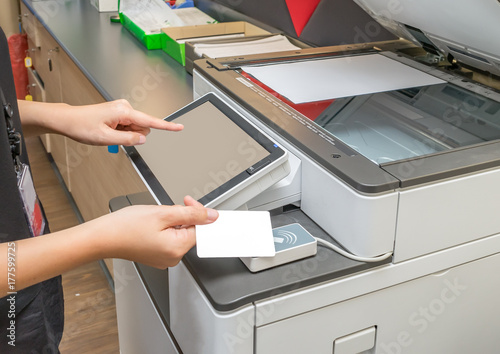 Women hold card for scanning key card to access Photocopier Security system concept