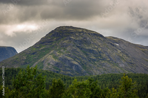 Top mountain Khibiny in the form of a background of the cloudy sky.