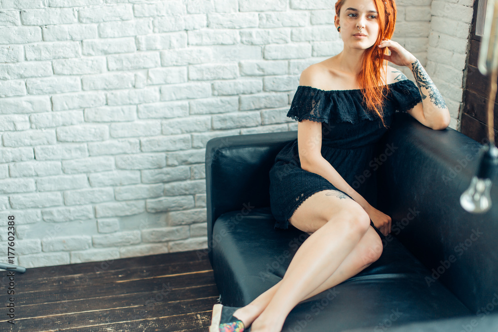 Curvy Raven Haired Redhead Woman With Dreadlocks And Tattoo Poses On Sofa Stock Foto Adobe Stock