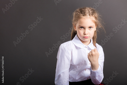 Young girl making a fight gesture isolated on studio background photo