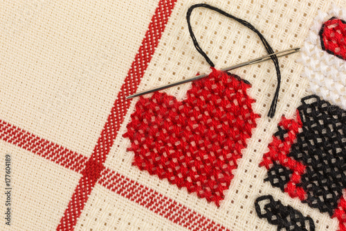 heart embroidered in cross stitch on canvas
