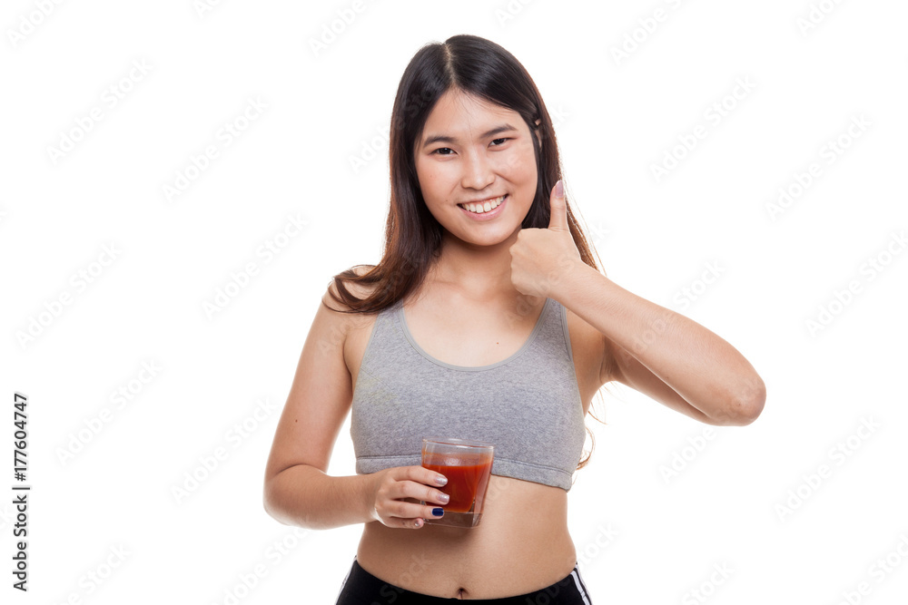 Beautiful healthy Asian girl thumbs up with tomato juice. Beautiful healthy Asian girl thumbs up with tomato juice.