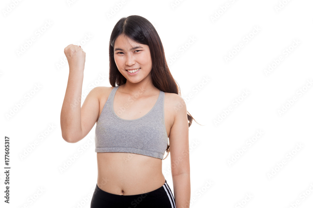 Successful young Asian woman in sport dresses hold fist up. Successful young Asian woman in sport dresses hold fist up.