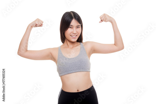 Beautiful young Asian woman in sport dresses flex bicep. © halfbottle