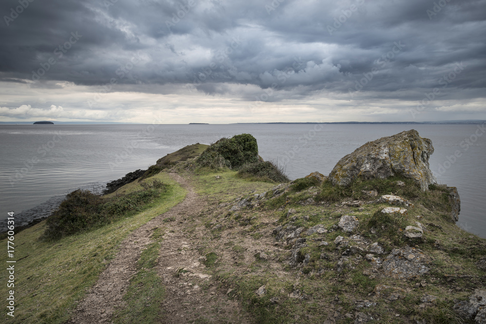 Landscape image looking out to sea with stormy sky