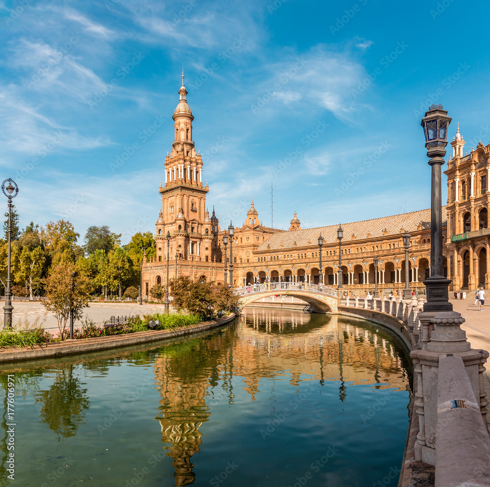 North tower with reflection in river at the Place of Espana in Sevilla, Spain