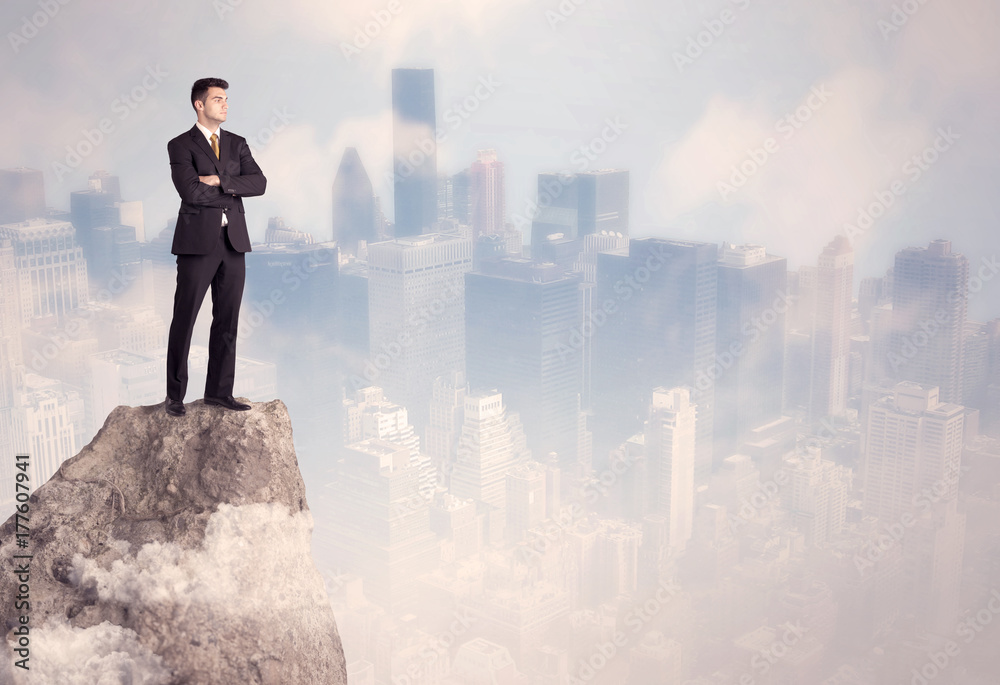 Winner urban businessman on top of stone Winner urban businessman on top of stone