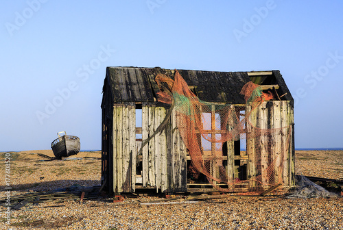 An abandoned boat and fisherman's hut on the shingle beach at Dungeness  photo