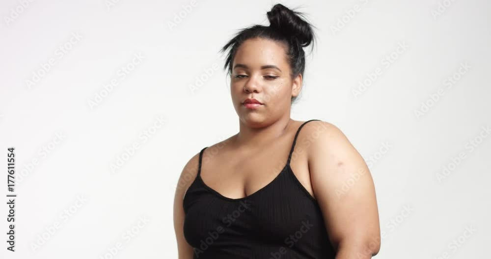 Strong confident beautiful plus size African American model in black one piece suit on white background