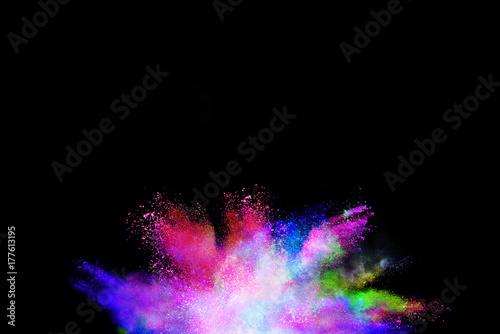 Splash of colorful powder over black background. © piyaphong