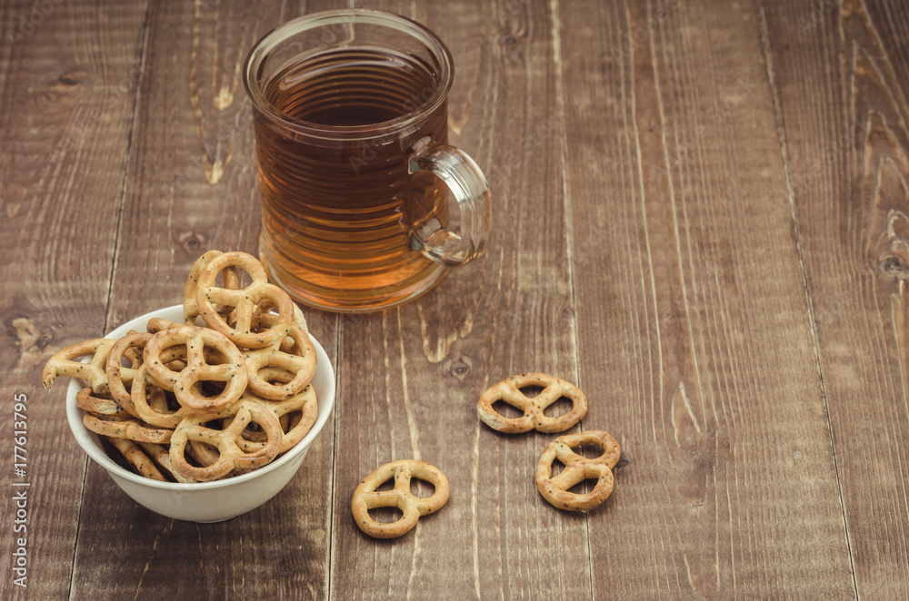 glass of tea and pretzel on a wooden table/glass of tea and pretzel on a wooden table. With copy space