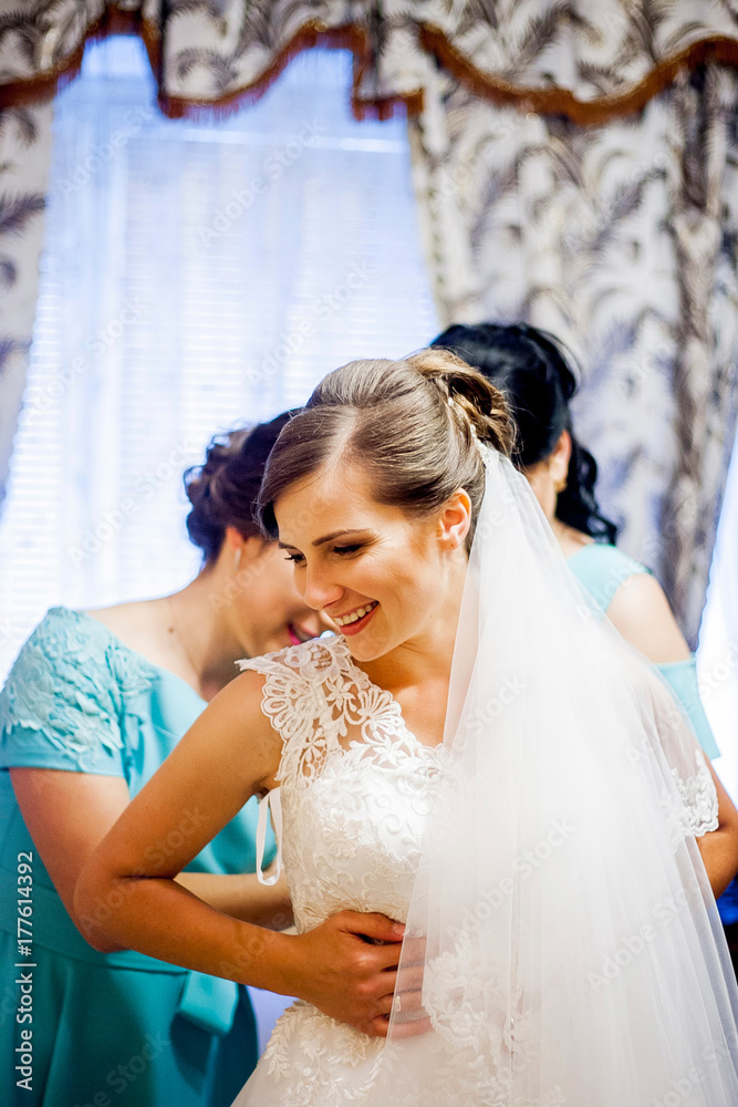 Bride's girlfriends help dress her up Bride's girlfriends help dress her up