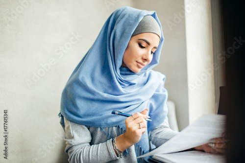 beautiful Muslim woman working with documents. business, lifestyle concept