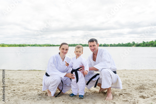Obraz na płótnie Father, mother and little son - sport family. Young family in kimono outdoors. w salonie