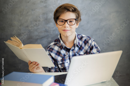 Teen boy reading book and u...