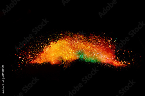 Splash of colorful powder over black background.