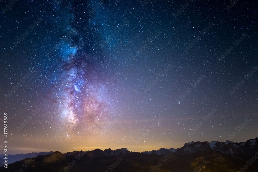 Naklejka premium The Milky Way and the starry sky over the French Alps and the majestic Barre des Ecrins.