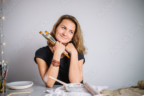 portrait of Potter with brushes in her workplace photo