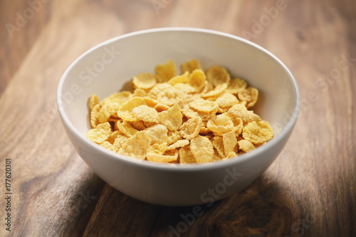 corn flakes in white bowl on table closeup