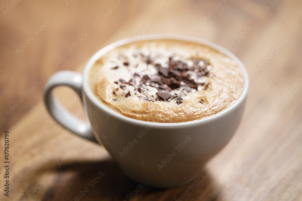 fresh cappuccino with chocolate flakes on wood table fresh cappuccino with chocolate flakes on wood table