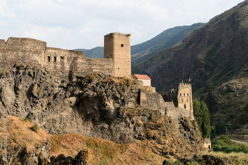 Ancient castle in the mountains in the light of the setting sun, Georgia