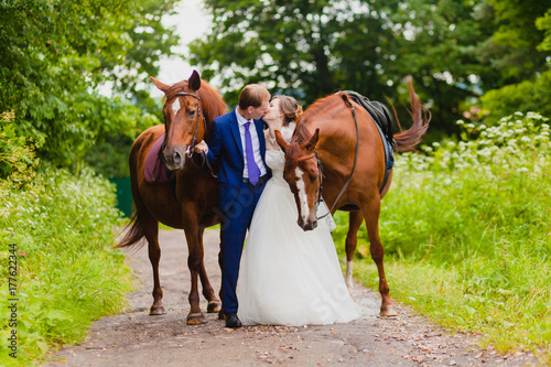 Beautiful newlyweds with two horses © meatbull