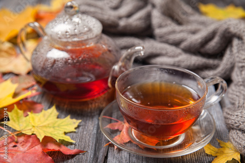 Autumn Still Life: Tea on maple leaves on a wooden table