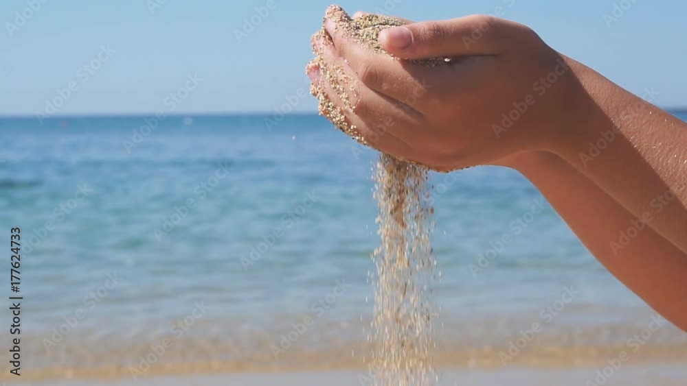 Sea sand running through a boy hands. Slow Motion Sea sand running through a boy hands. Slow Motion