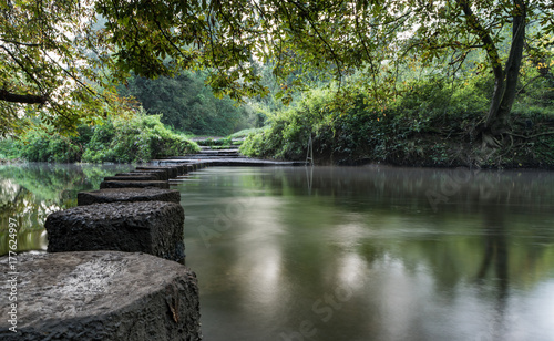 Stepping stones across the river Mole at Boxhill, Surrey, England photo