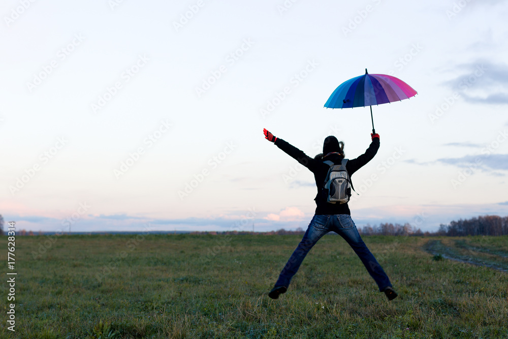 Young emotional woman with an umbrella on a walk, nature light Young emotional woman with an umbrella on a walk, nature light