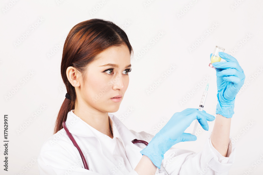 Syringe with vial on hands in a latex glove of a female doctor,administer the injection. Syringe with vial on hands in a latex glove of a female doctor,administer the injection.