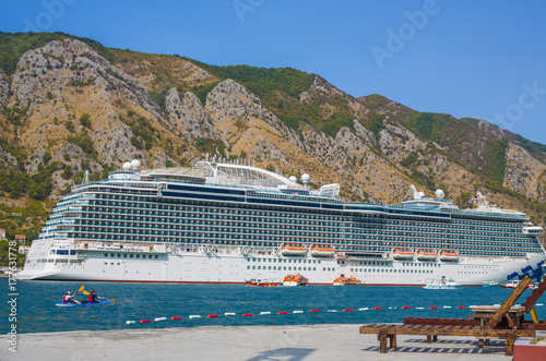 Luxury cruise ship sailing from port on sunset