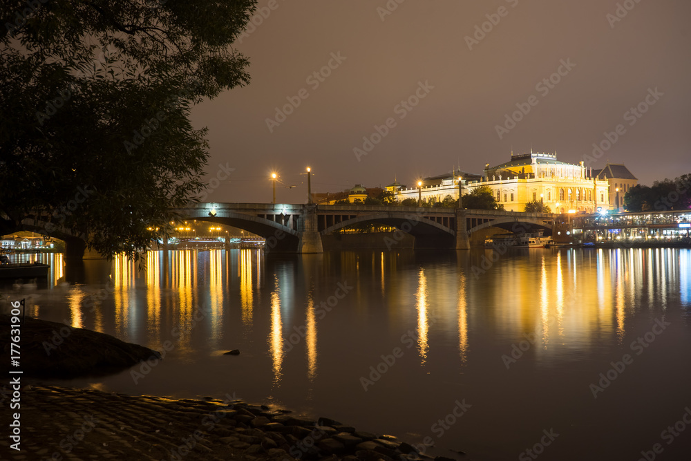 Manes bridge in Prague, Czech Republic. Light of lanterns reflected in the Vltava River