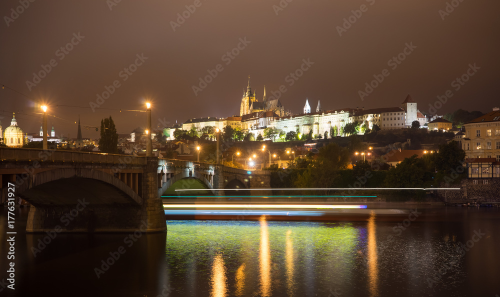 Charles Bridge and Prague Castle in Prague. Czech Republic. Lights trails from boats walking along the river