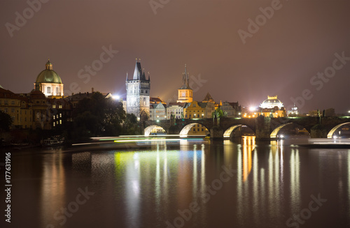 Charles Bridge and the Mill peninsula in Prague. Czech Republic. Light trails from boats walking along the river © den781