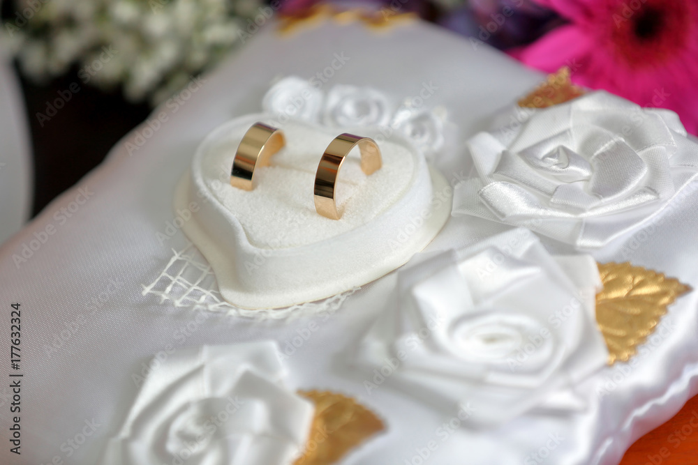 Golden wedding rings on the table before wedding ceremony Golden wedding rings on the table before wedding ceremony