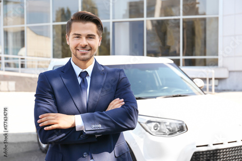 Salesman standing near new ...