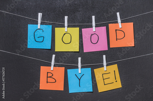 The word "Good bye!" on colored stickers on a dark background close up
