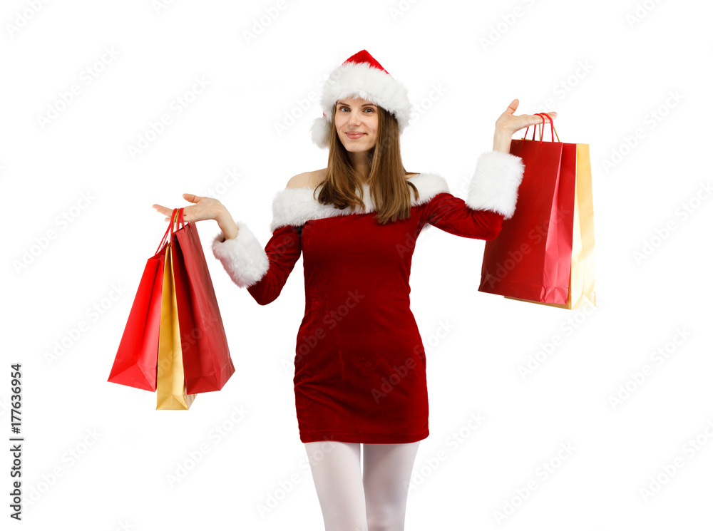 Beautiful woman in Santa Claus clothes holding shopping bags on white background Beautiful woman in Santa Claus clothes holding shopping bags on white background