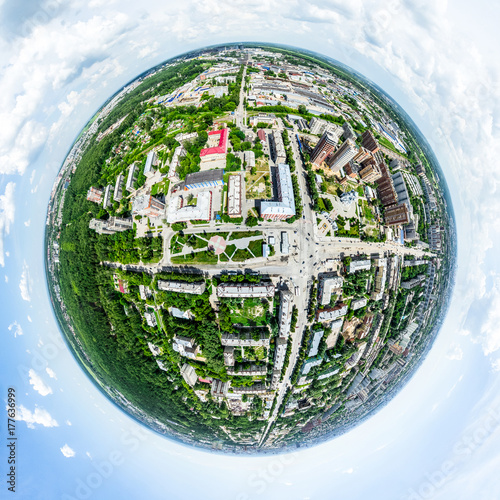 Aerial city view with crossroads and roads  houses  buildings  parks and parking lots  bridges. Helicopter drone shot. Wide Panoramic image.