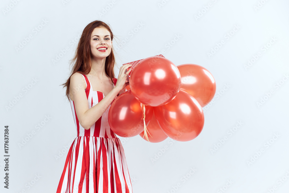 happy woman smiling in hand holding balloons on light background, celebrating, having fun happy woman smiling in hand holding balloons on light background, celebrating, having fun