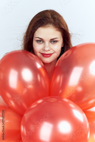 1723579 lovely woman with balloons on a light background portrait, holiday © SHOTPRIME STUDIO