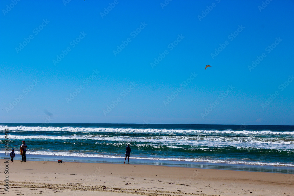 Fishing catch fish angle hook man fisher beach coast coastline waves Fishing catch fish angle hook man fisher beach coast coastline waves