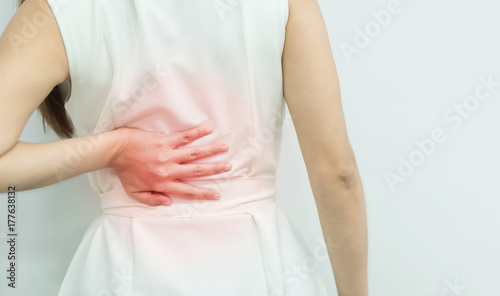 Wallpaper Mural A woman in white dress feeling pain on his back. Office syndrome. Back pain from work. Herniated nucleus pulposus. spine pain. spinal degeneration. Torontodigital.ca