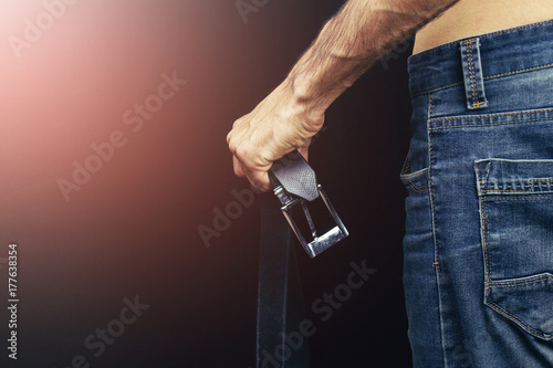 Obraz na plátně A strict father holds the girdle, the concept of violence