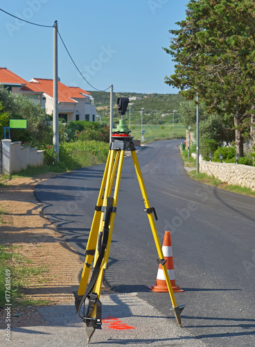 geodetic measuring station on the street and warning cone