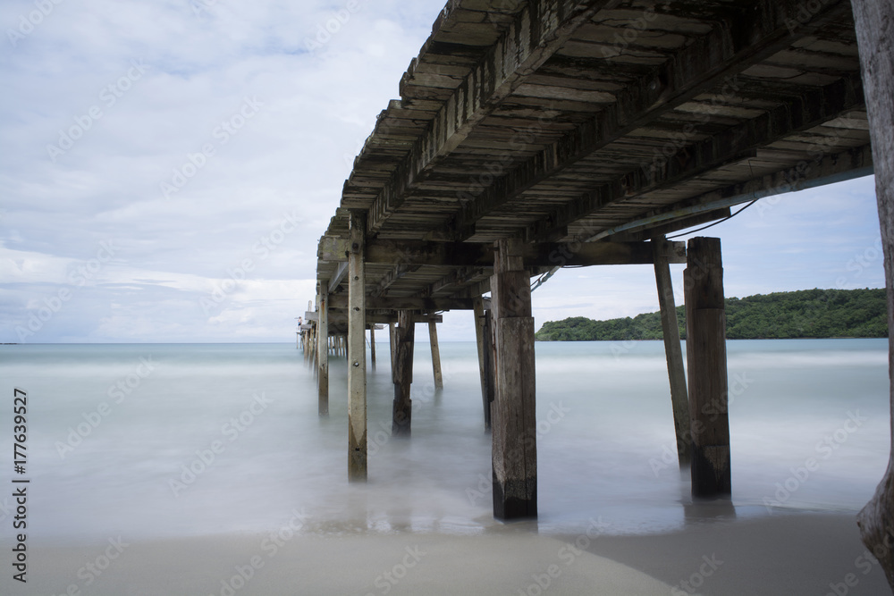 wooden bridge (below view) / A wooden bridge extends into the sea at Ao Phrao, Koh Kood Island Trat province Thailand.