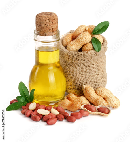 peanut oil in a glass bottle with peanuts in bag