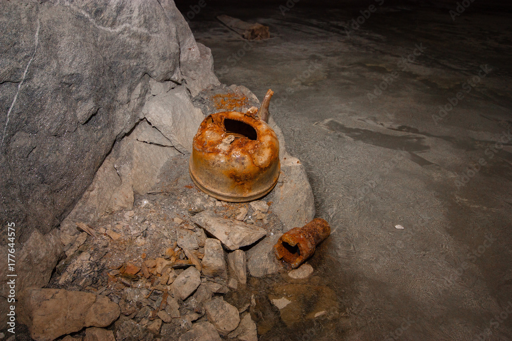 Underground abandoned ore mine shaft tunnel gallery with teapot